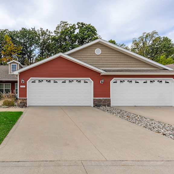 a red house with a white garage door.