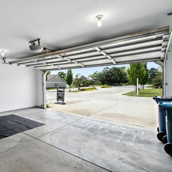 a parking garage with a black mat on the floor.