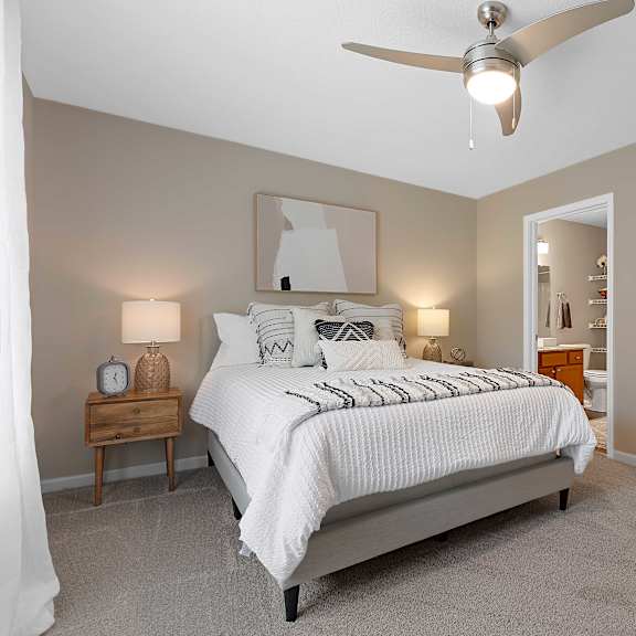 a bedroom with a large bed and a ceiling fan.