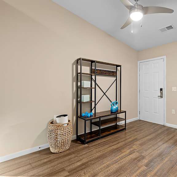 a room with a wooden floor and a white door.