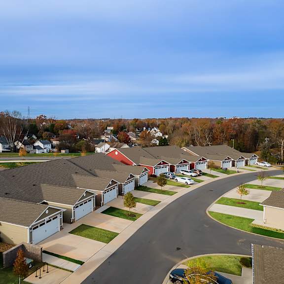 a residential neighborhood with houses and a curved road.