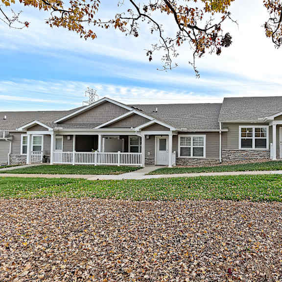 a row of houses with a gravel driveway in front.