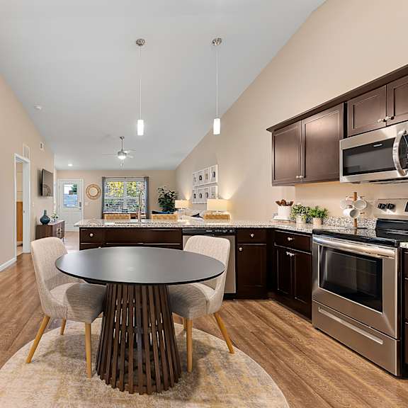 a modern kitchen with a dining table and chairs.