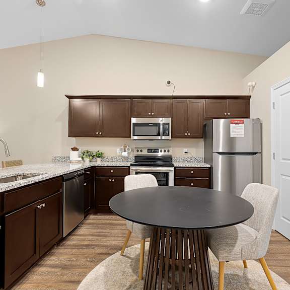 a kitchen with a table and chairs.