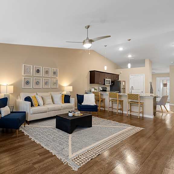 a living room with a blue chair and a white couch.