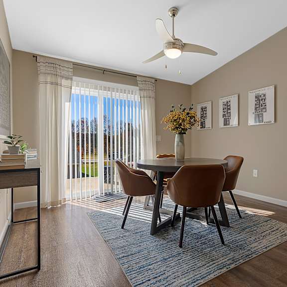 a dining room with a table and chairs.