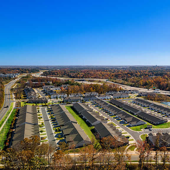 a suburban neighborhood with rows of houses and a clear blue sky.