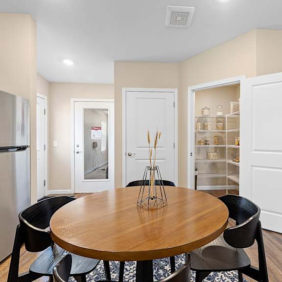 a kitchen with a table and chairs in the middle of the room.