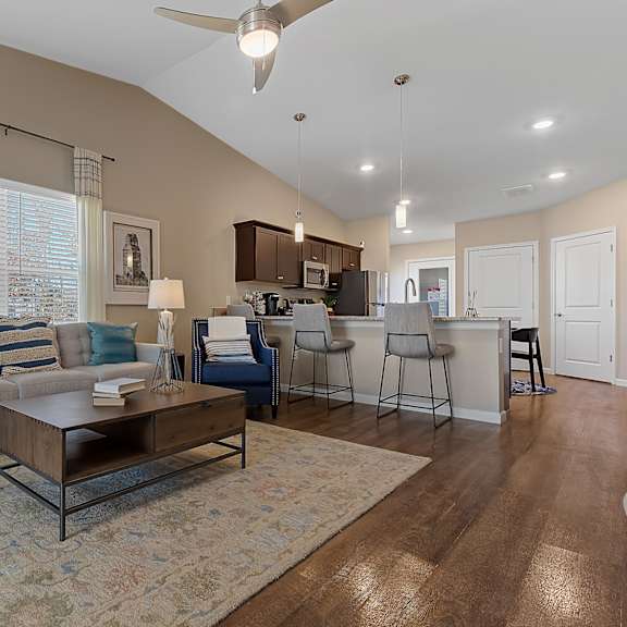 a living room with a couch, chairs, and a coffee table.