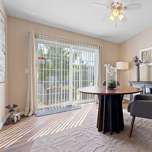 a living room with a grey chair and a black table.