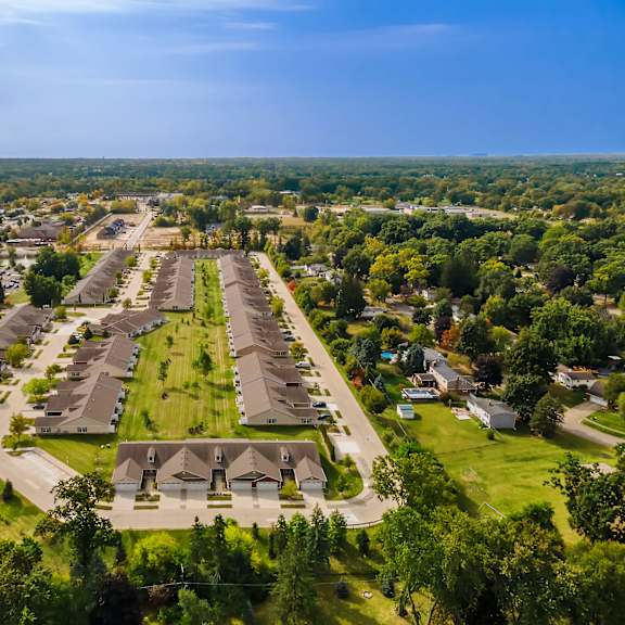 a bird's eye view of a residential area with houses and greenery.