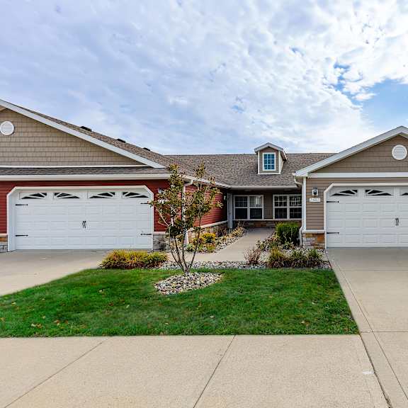 a two-car garage is attached to a house.