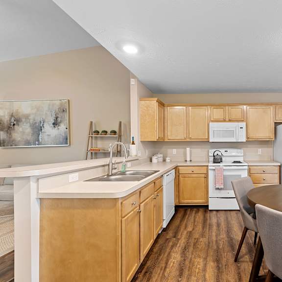 a kitchen with wooden cabinets and a white refrigerator.