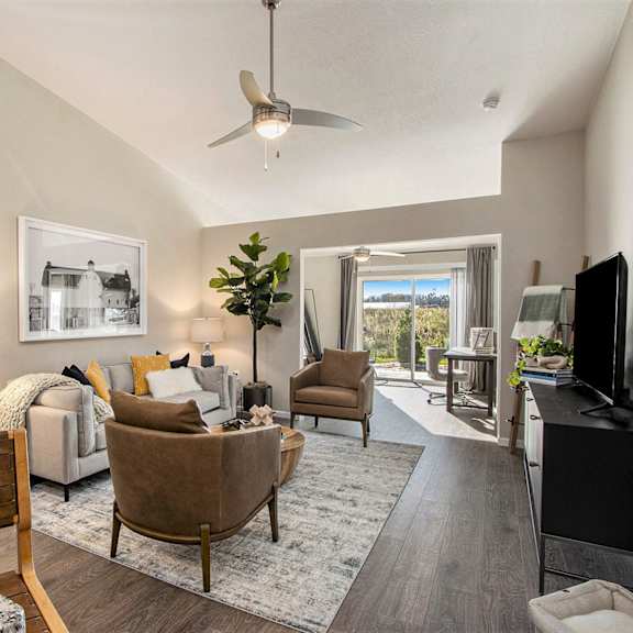 a living room with a brown chair and a grey couch.
