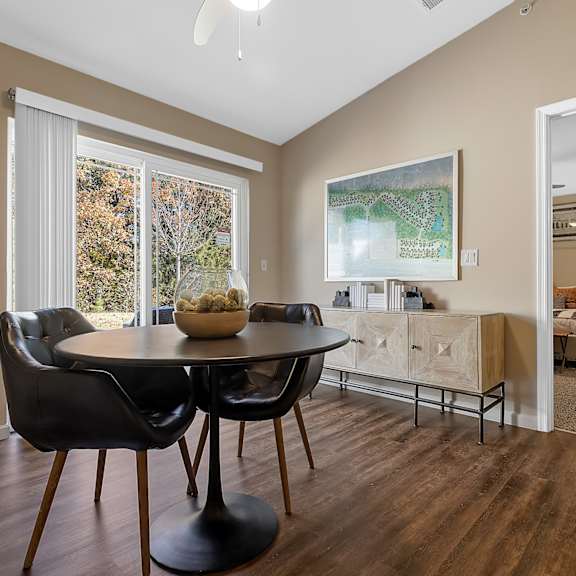 a dining room with a table and chairs.