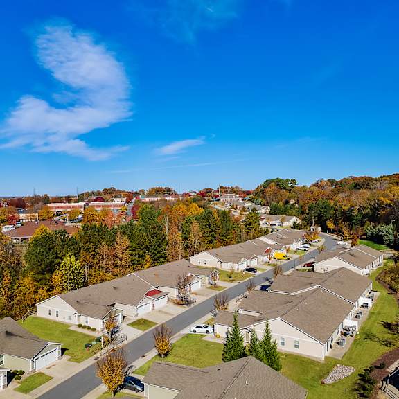 a suburban neighborhood with houses and trees in autumn colors.