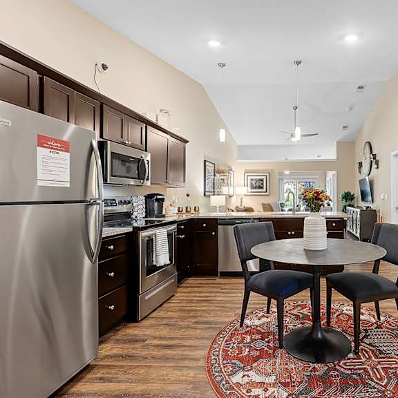 a modern kitchen with a dining table and chairs.