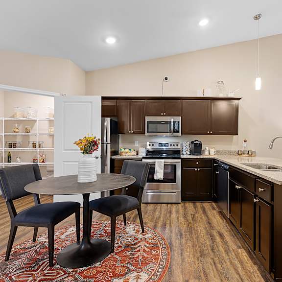 a kitchen with a table and chairs in the middle of the room.