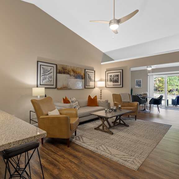 a living room with a brown chair and a white counter.