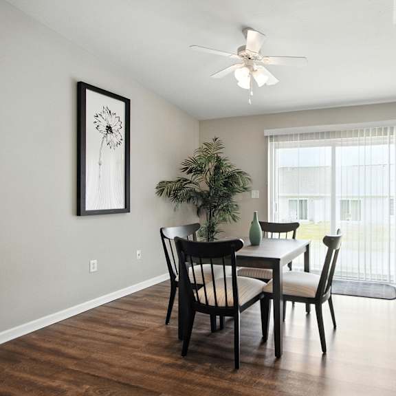 a dining room with a table and chairs.