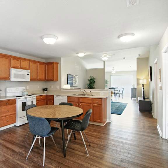 a kitchen with a white refrigerator and wooden cabinets.