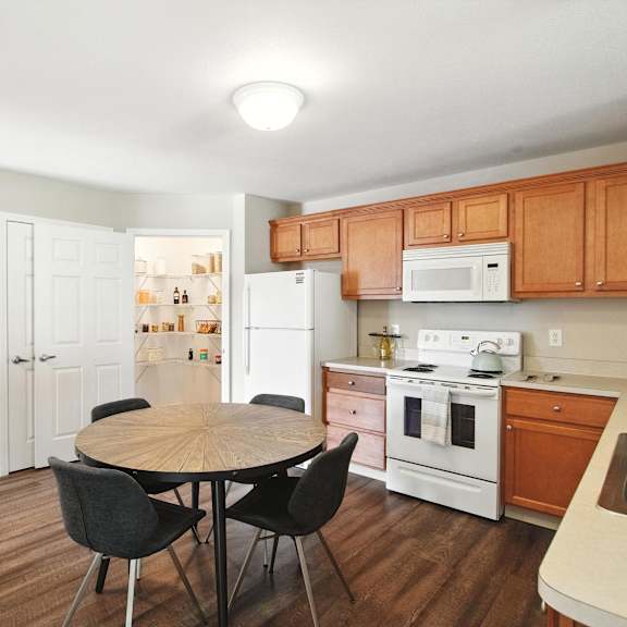 a kitchen with a table and chairs.
