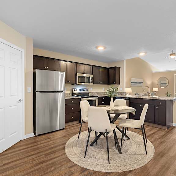a modern kitchen with a dining table and chairs.
