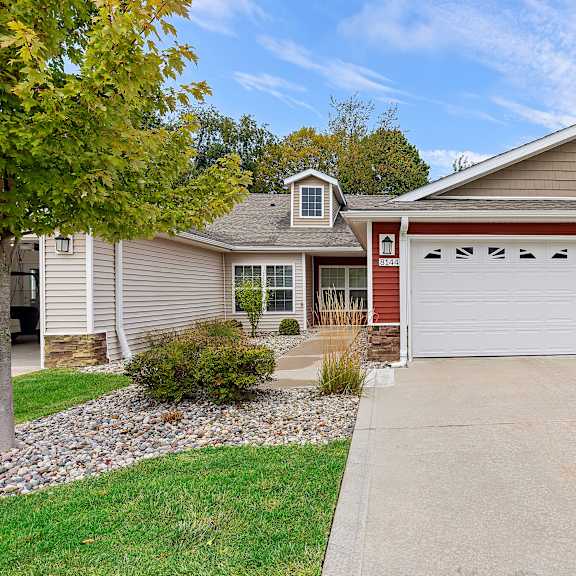 a house with a red garage door and a white garage door.