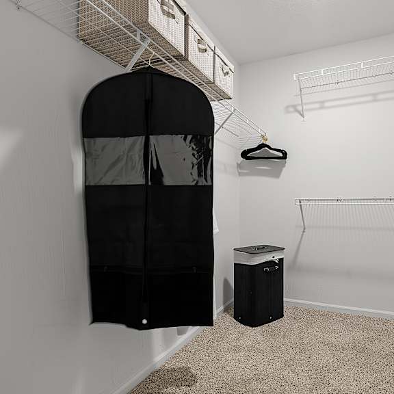a room with a black closet and a trash can.