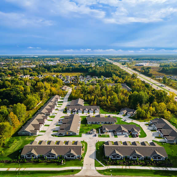 a bird's eye view of a residential area with houses and trees.