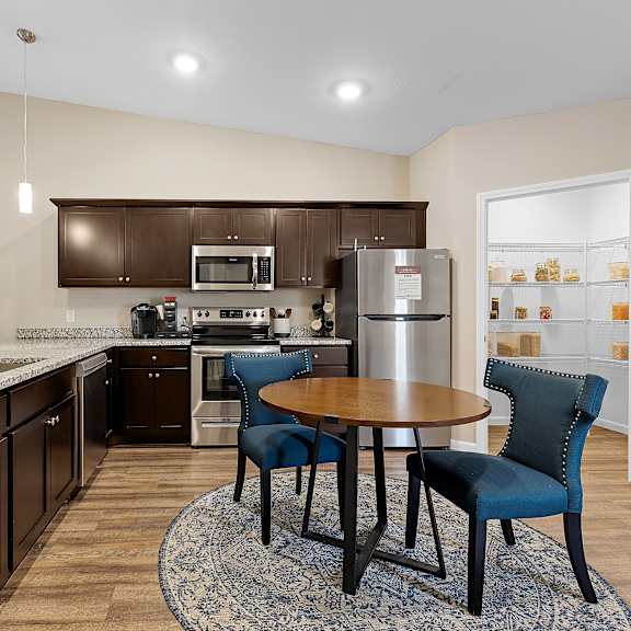 a kitchen with a table and chairs in the middle of the room.