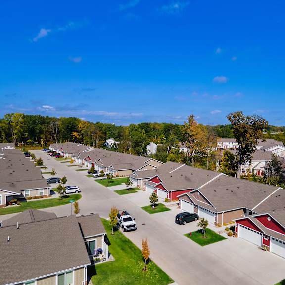 a suburban neighborhood with houses and cars parked in the driveways.
