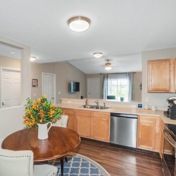 a kitchen with a table and chairs in the middle of the room.