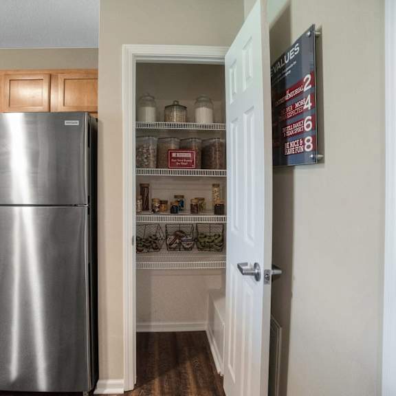 a kitchen with a stainless steel refrigerator and wooden cabinets.