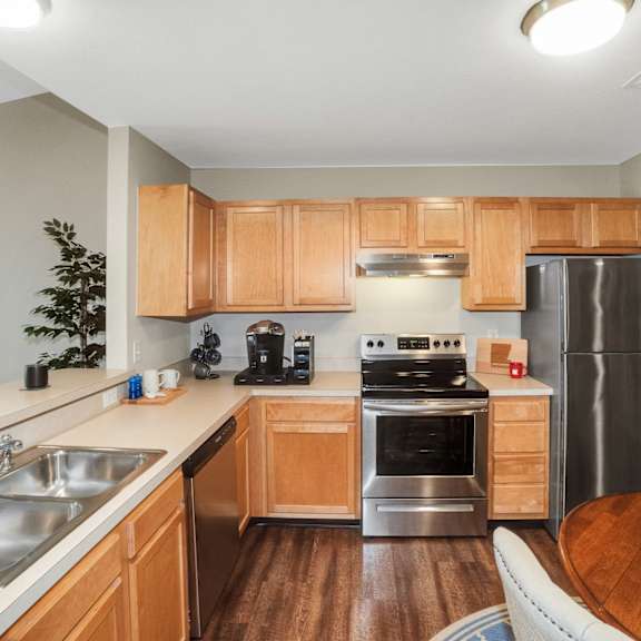 a kitchen with wooden cabinets and stainless steel appliances.