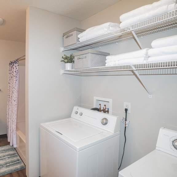 a bathroom with a toilet, sink, and towel rack.