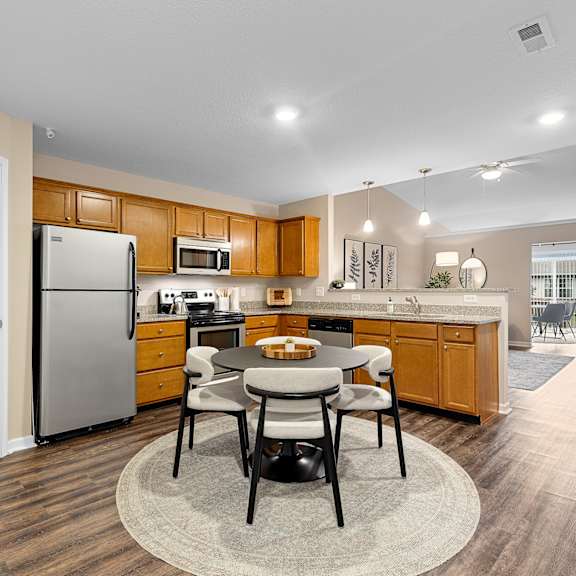 a kitchen with a table and chairs in the middle of the room.
