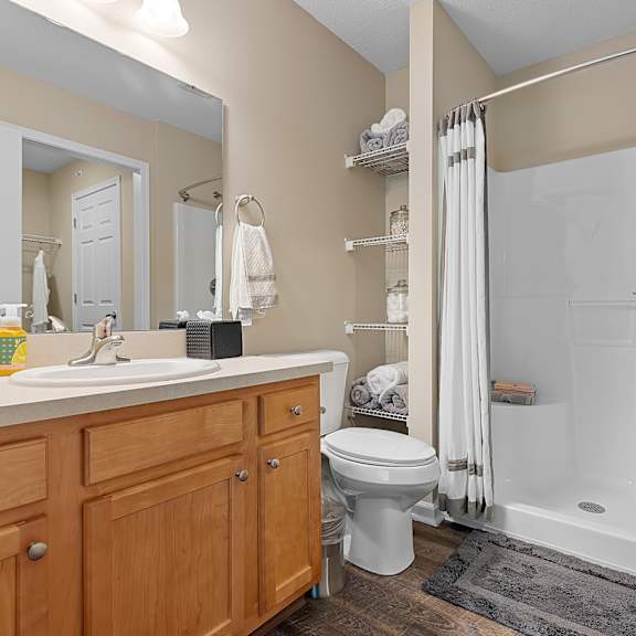 a bathroom with a white sink, toilet, and bathtub.