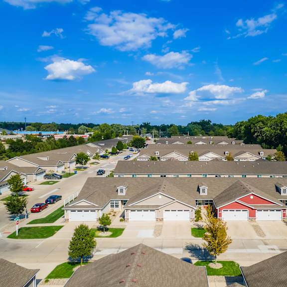 a suburban neighborhood with houses and cars parked in the driveways.
