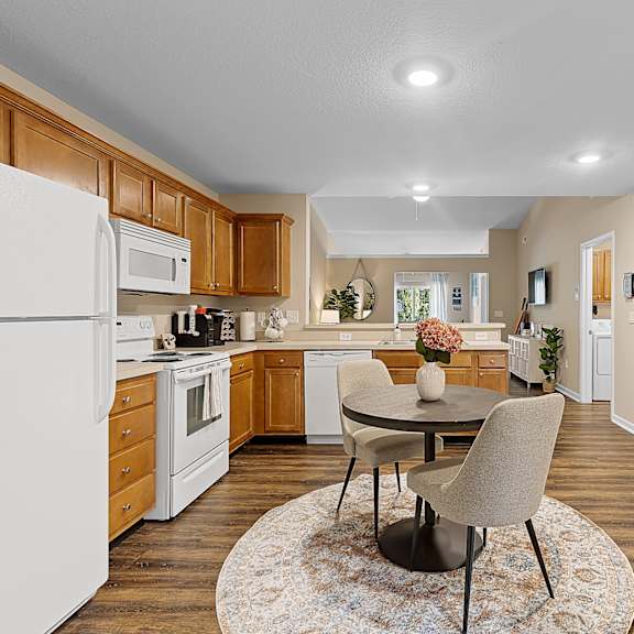 a kitchen with a white refrigerator and wooden cabinets.