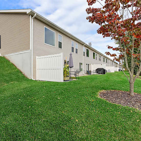 a house with a brown roof and a white garage door.