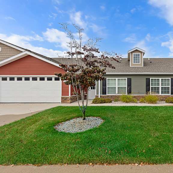 a house with a red garage door and a grey roof.