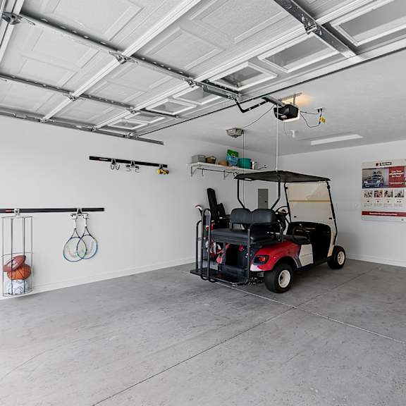 a golf cart is parked in a large garage.