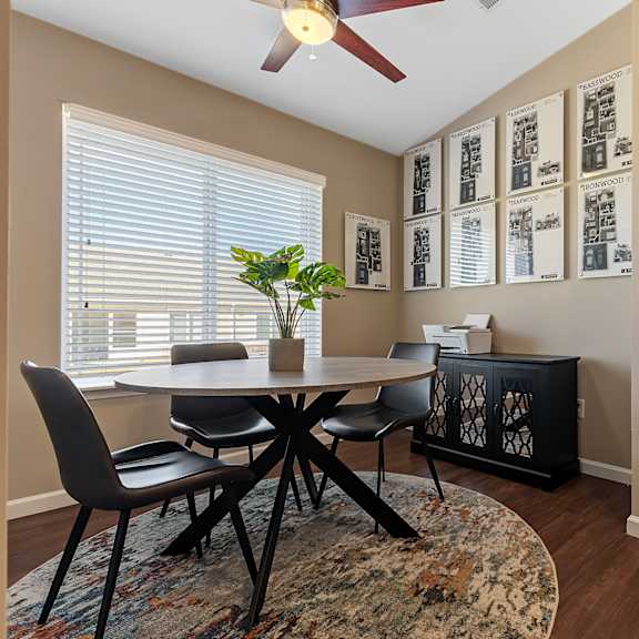 a dining room with a round table and chairs.