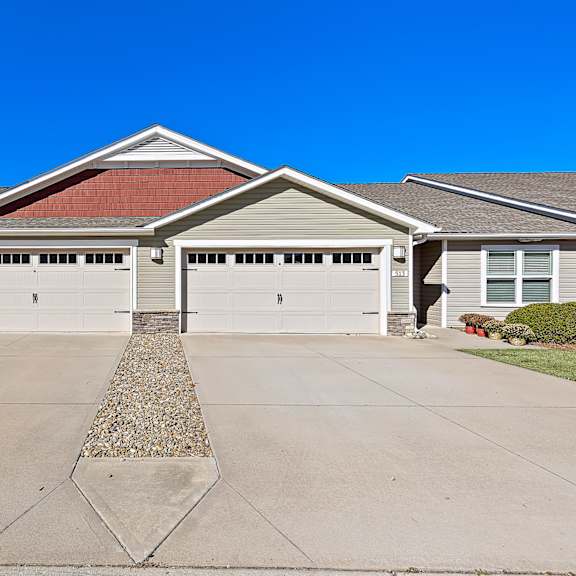 a house with a red tile roof and two garages.