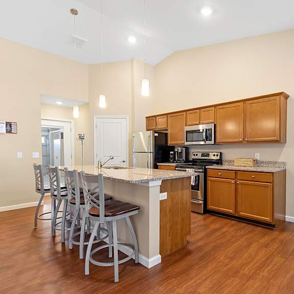 a kitchen with wooden cabinets and a white island.