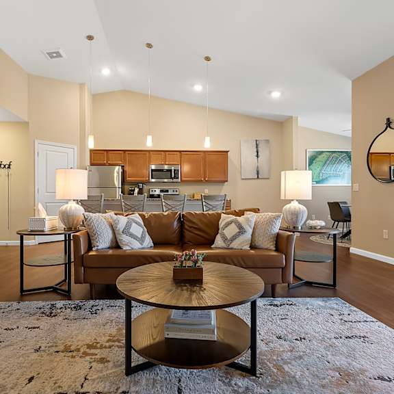 a living room with a brown couch and a coffee table.