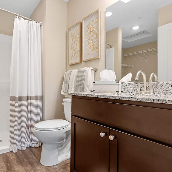 a white toilet sits in a bathroom next to a shower.