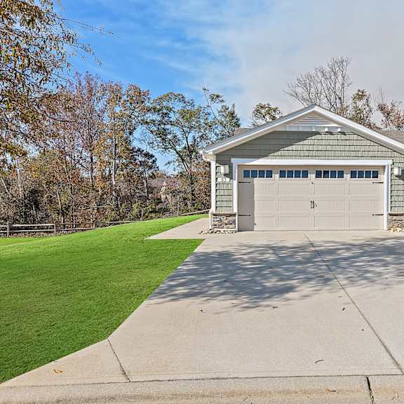 a two-car garage with a driveway in front.