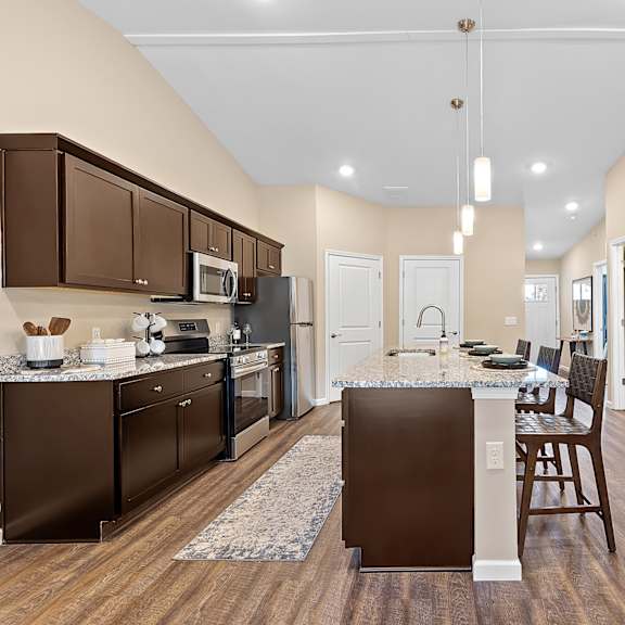 a kitchen with brown cabinets and a white island.